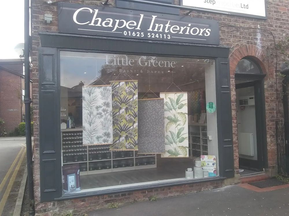 Shopfront painted in a dark heritage colour on a brick building