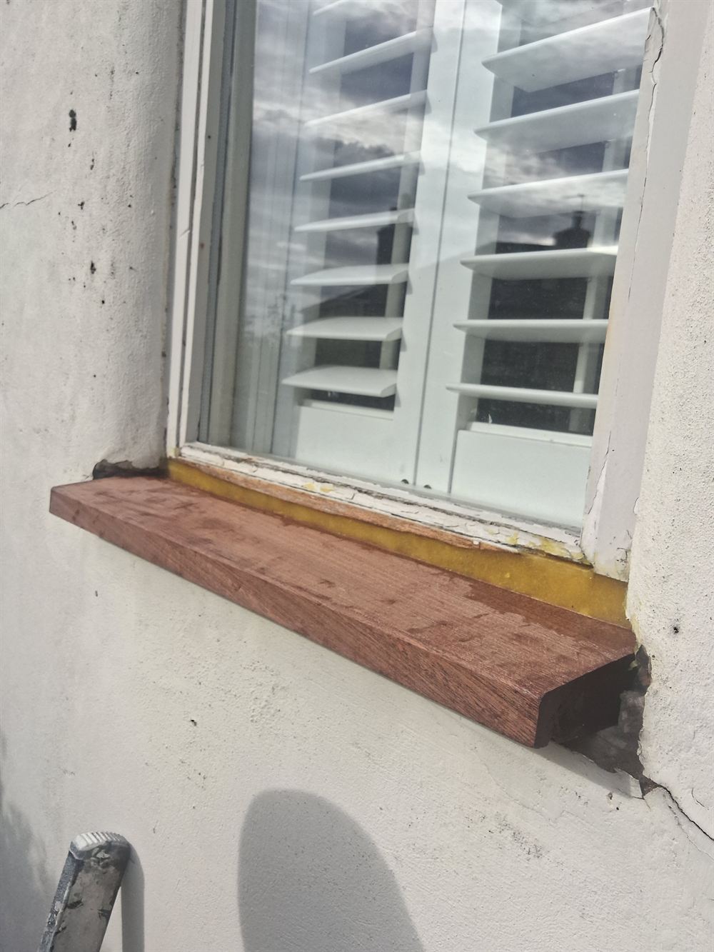 A repaired window cill rebuilt in hardwood, ready to be primed and painted